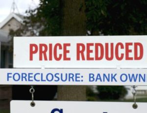 Foreclosed homes are owned by a delinquent taxpayer